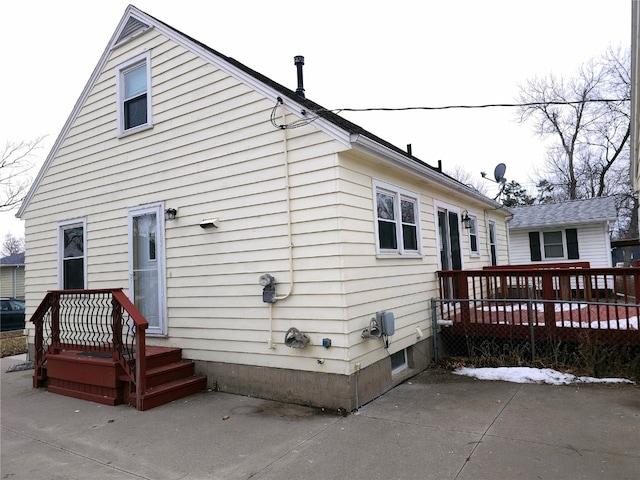 back of house with a deck