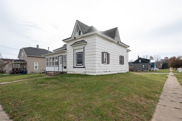 view of side of home with a lawn