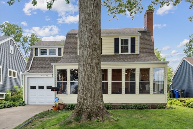 view of front of home featuring a garage and a front lawn