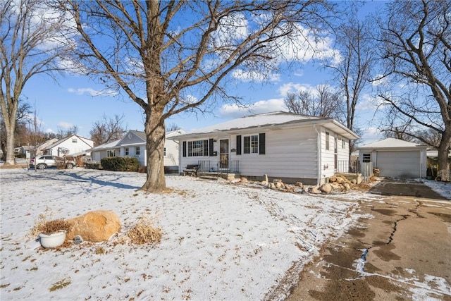 ranch-style home with a garage and an outbuilding