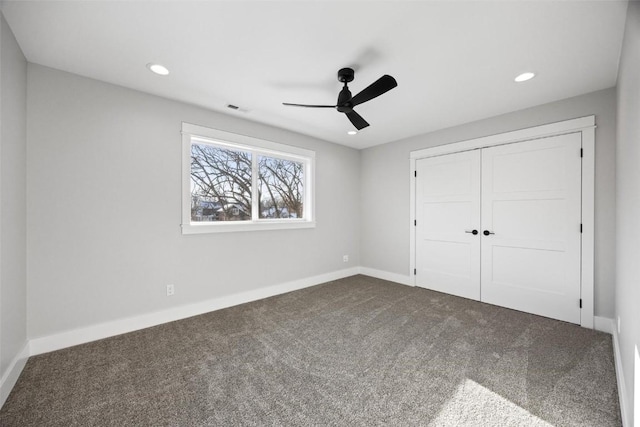 unfurnished bedroom featuring ceiling fan, a closet, and carpet