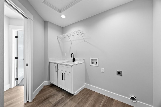 laundry area featuring sink, dark hardwood / wood-style flooring, hookup for a washing machine, and hookup for an electric dryer