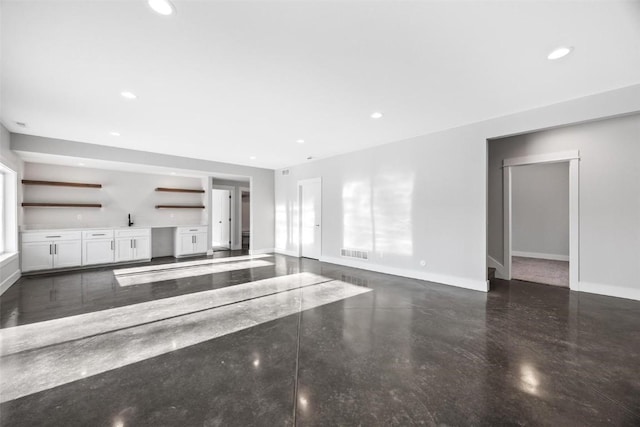 unfurnished living room with sink