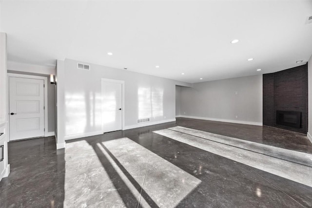 unfurnished living room featuring a brick fireplace