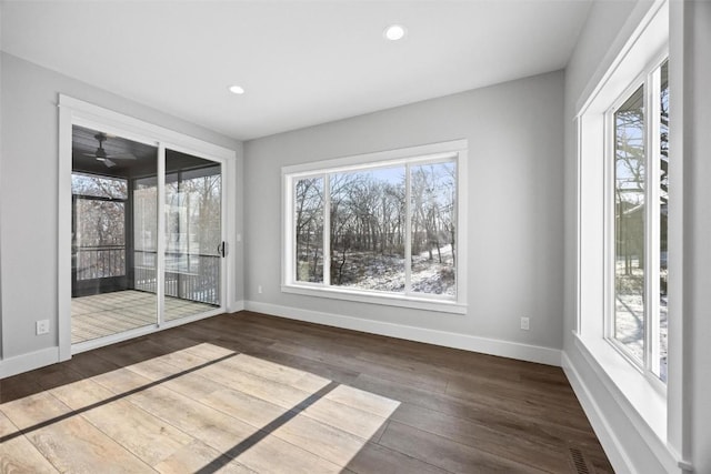 spare room with dark wood-type flooring and ceiling fan