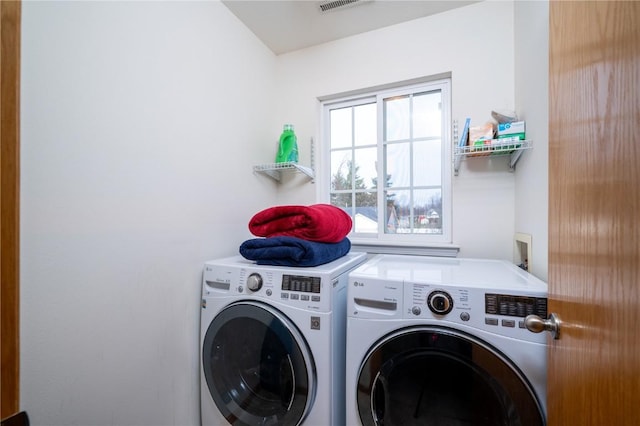 washroom with washing machine and clothes dryer