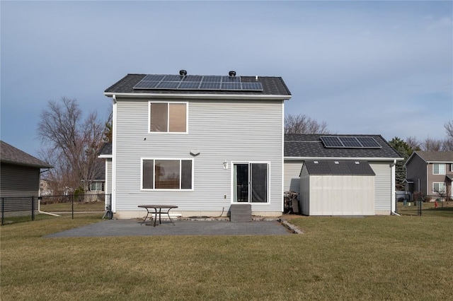 rear view of property featuring a patio, a storage unit, and a yard