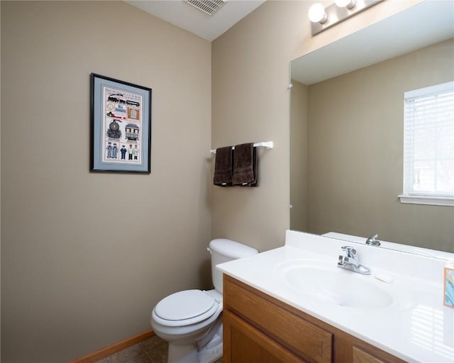 bathroom with tile patterned floors, vanity, and toilet