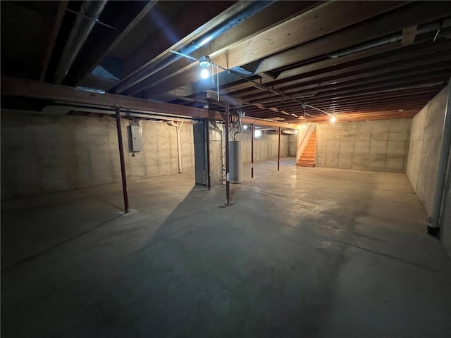 basement featuring gas water heater and electric panel