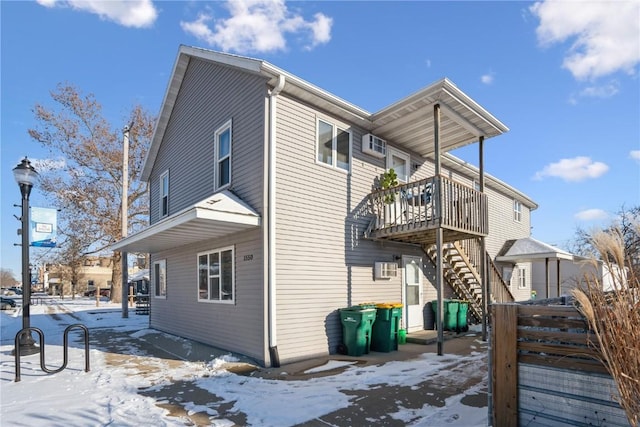 snow covered property featuring a deck