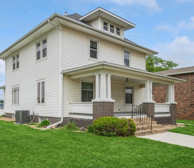 view of front of house with a porch, central air condition unit, and a front lawn