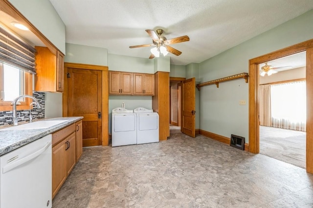 laundry area featuring sink, ceiling fan, separate washer and dryer, and a textured ceiling