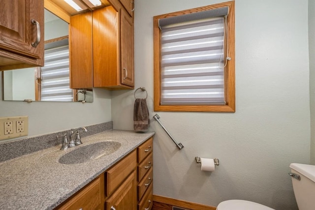 bathroom with vanity and toilet