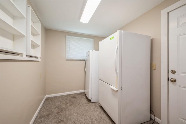 clothes washing area with light colored carpet