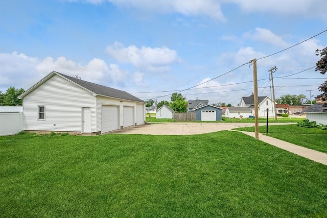 view of yard featuring a garage and an outdoor structure