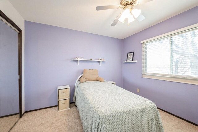 bedroom with ceiling fan and light carpet