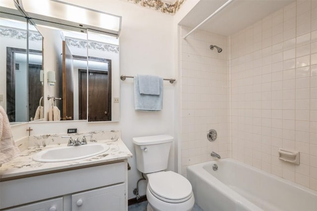 full bathroom featuring toilet, tiled shower / bath combo, and vanity