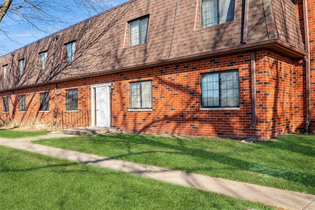 rear view of house with a yard