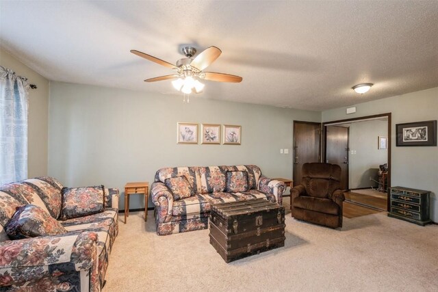 carpeted living room with a textured ceiling and ceiling fan