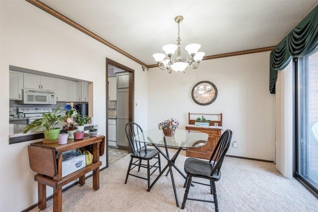 dining space with ornamental molding, a chandelier, and light carpet