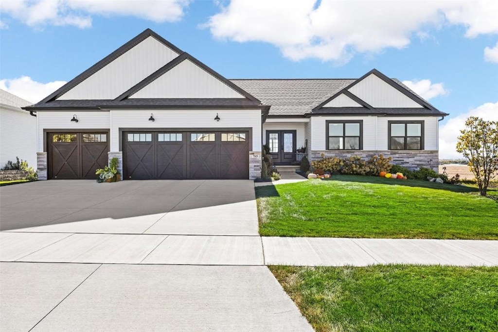 view of front of property with a front yard and a garage