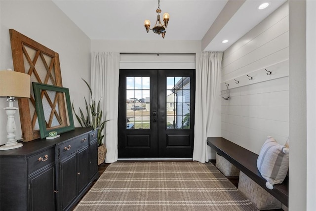 mudroom with a notable chandelier and french doors