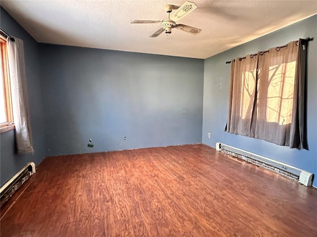 spare room with a baseboard radiator, a textured ceiling, ceiling fan, and hardwood / wood-style flooring