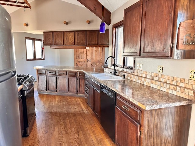 kitchen featuring range with gas cooktop, vaulted ceiling with beams, pendant lighting, sink, and black dishwasher