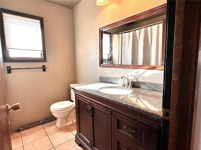 bathroom featuring vanity, tile patterned flooring, and toilet