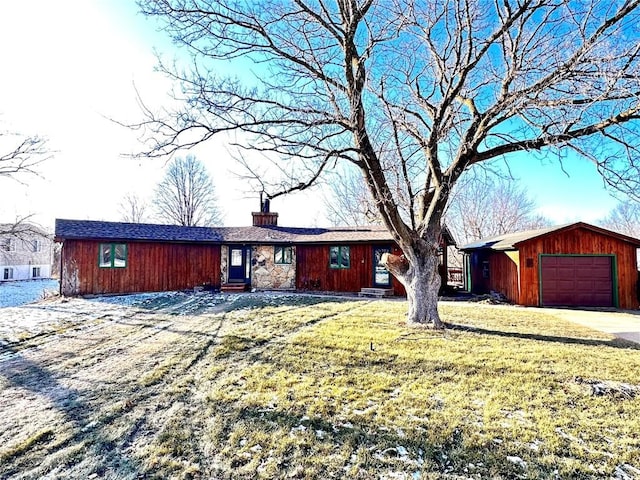 single story home featuring a front lawn and a garage