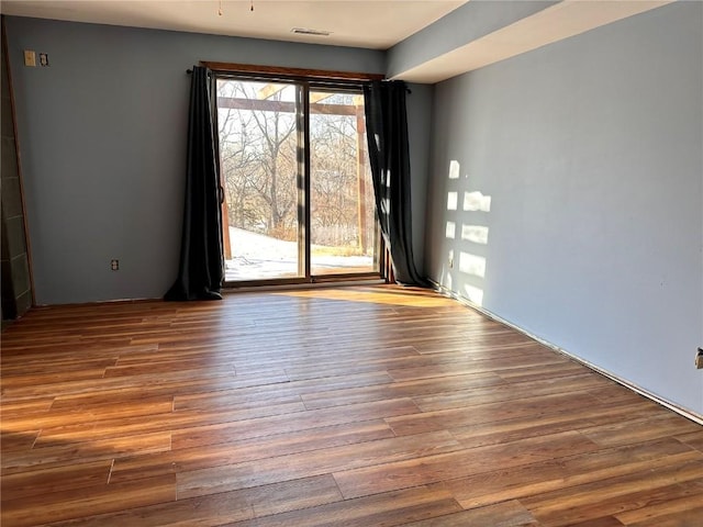 spare room with hardwood / wood-style floors