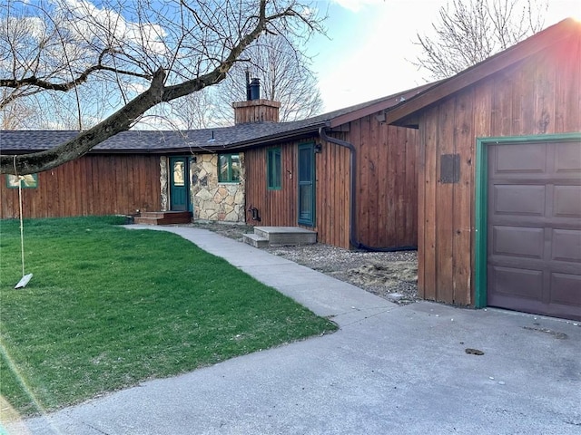145 Fairway Dr, Lisbon, IA 52253 - view of front of home with a front yard, a shingled roof, stone siding, and a chimney