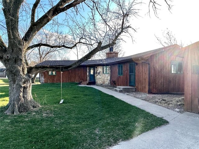 145 Fairway Dr, Lisbon, IA 52253 - view of front of home with a chimney and a front lawn