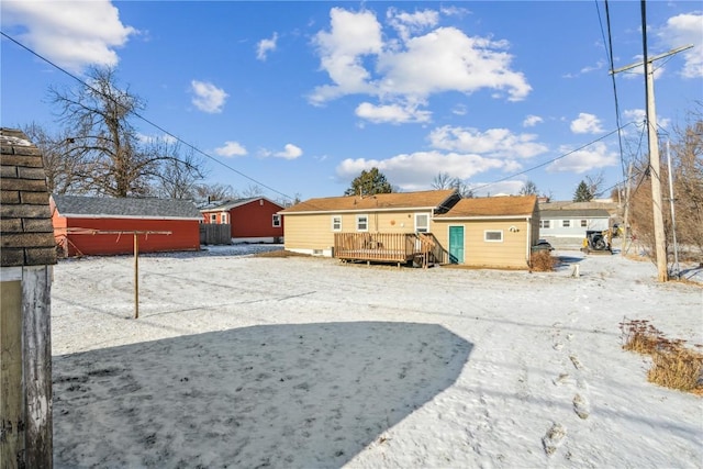 snowy yard with a wooden deck