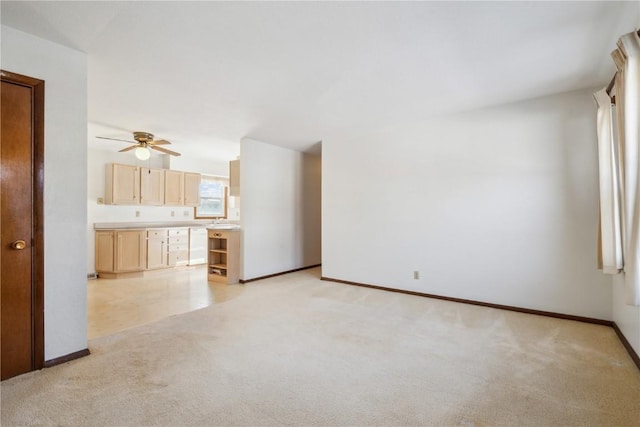 unfurnished living room with ceiling fan and light carpet