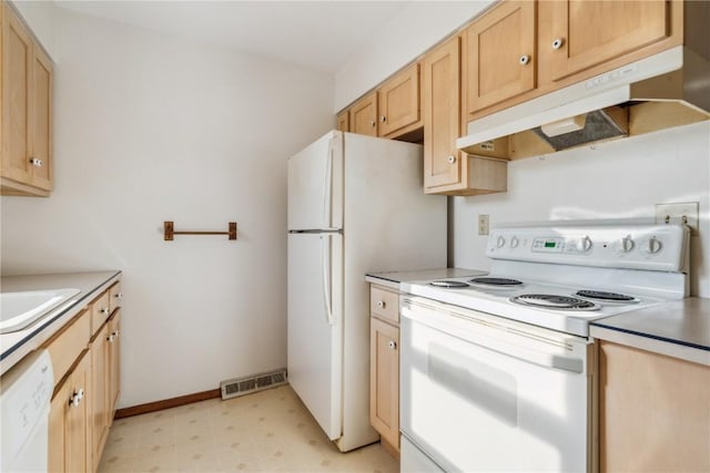 kitchen featuring sink, light brown cabinets, and white appliances