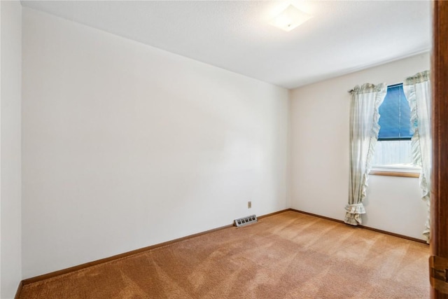 empty room with light colored carpet