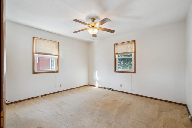 carpeted empty room featuring ceiling fan