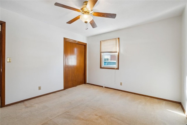 unfurnished bedroom with light colored carpet, ceiling fan, and a closet