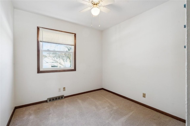 unfurnished room featuring ceiling fan and light colored carpet