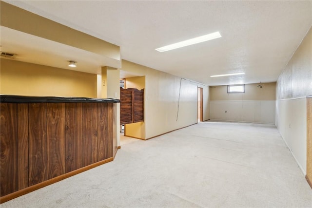 basement featuring light colored carpet