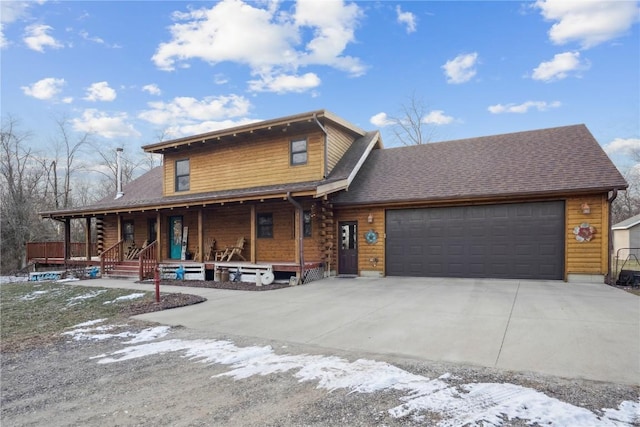 log home featuring a garage and covered porch