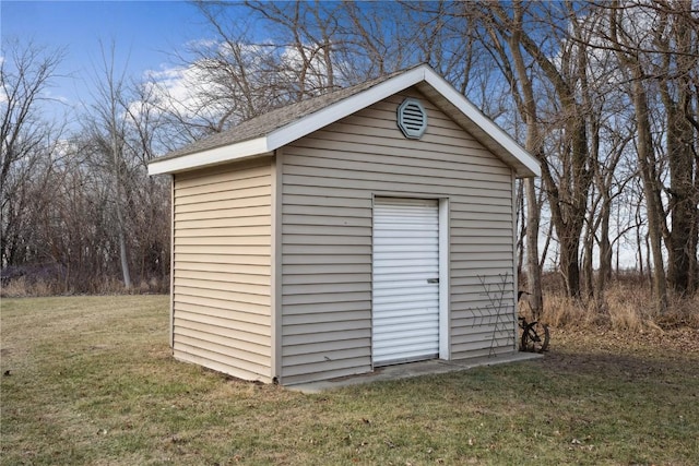 view of outdoor structure featuring a lawn