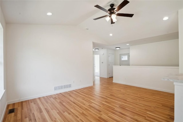 empty room featuring ceiling fan, vaulted ceiling, and light hardwood / wood-style flooring