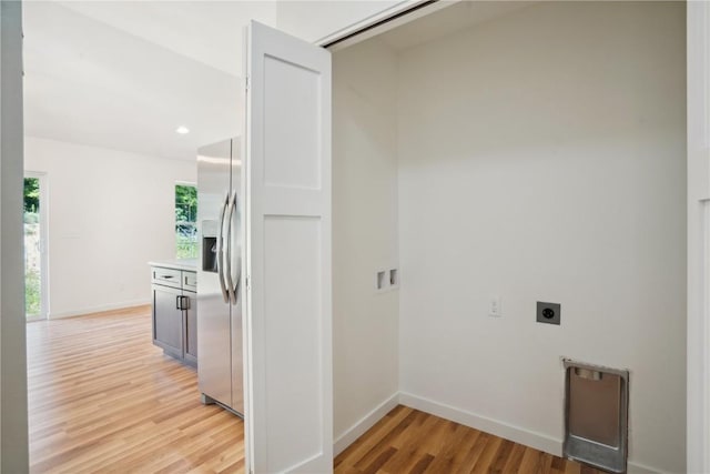 laundry room featuring hookup for an electric dryer and light hardwood / wood-style flooring