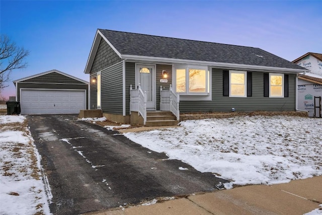 view of front of property with a garage and an outdoor structure