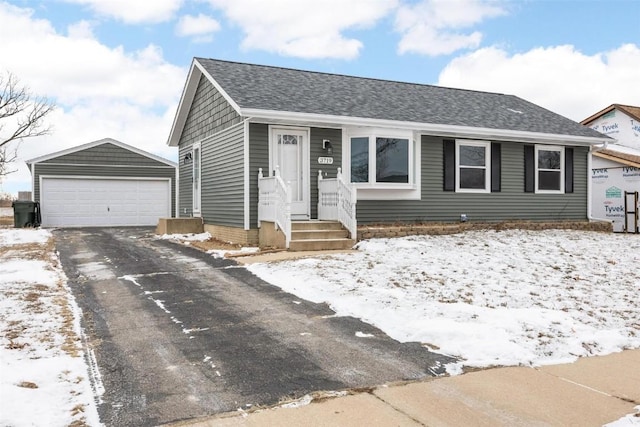 view of front of property with a garage and an outdoor structure