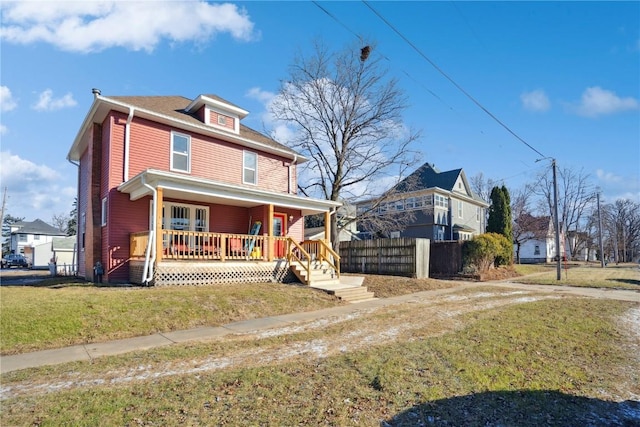 view of front of home with a front yard and covered porch