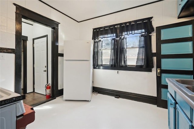 interior space featuring white fridge and concrete floors