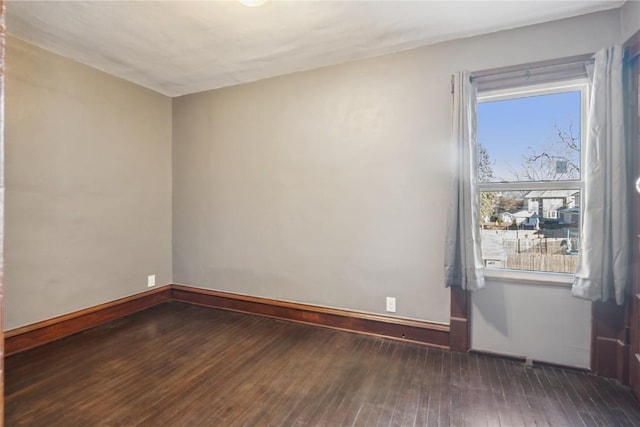 spare room with dark hardwood / wood-style floors